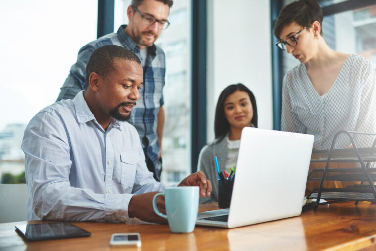 Group of colleagues using Azure DevOps services to maintain the production software of their business.