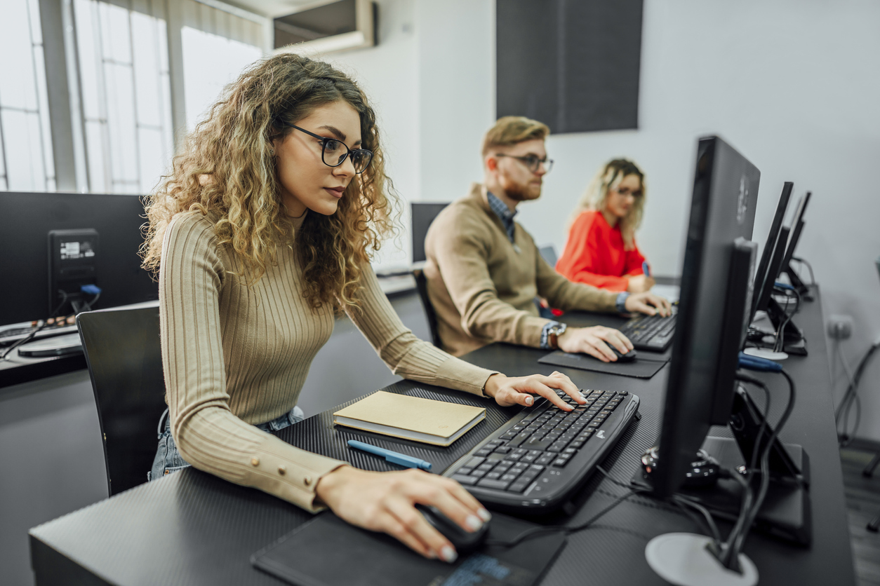 Group of employees using computers during a cybersecurity awareness training.