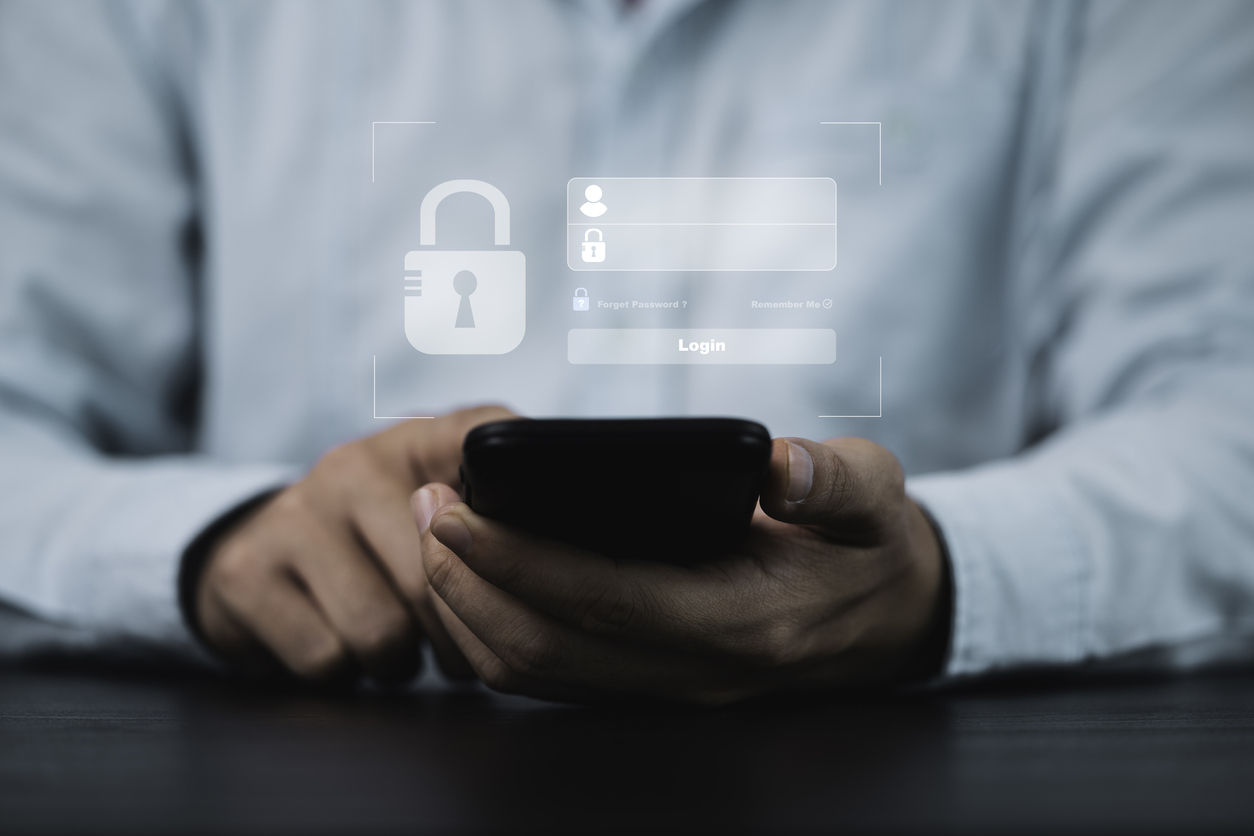 Businessman entering a verification code using a smartphone.