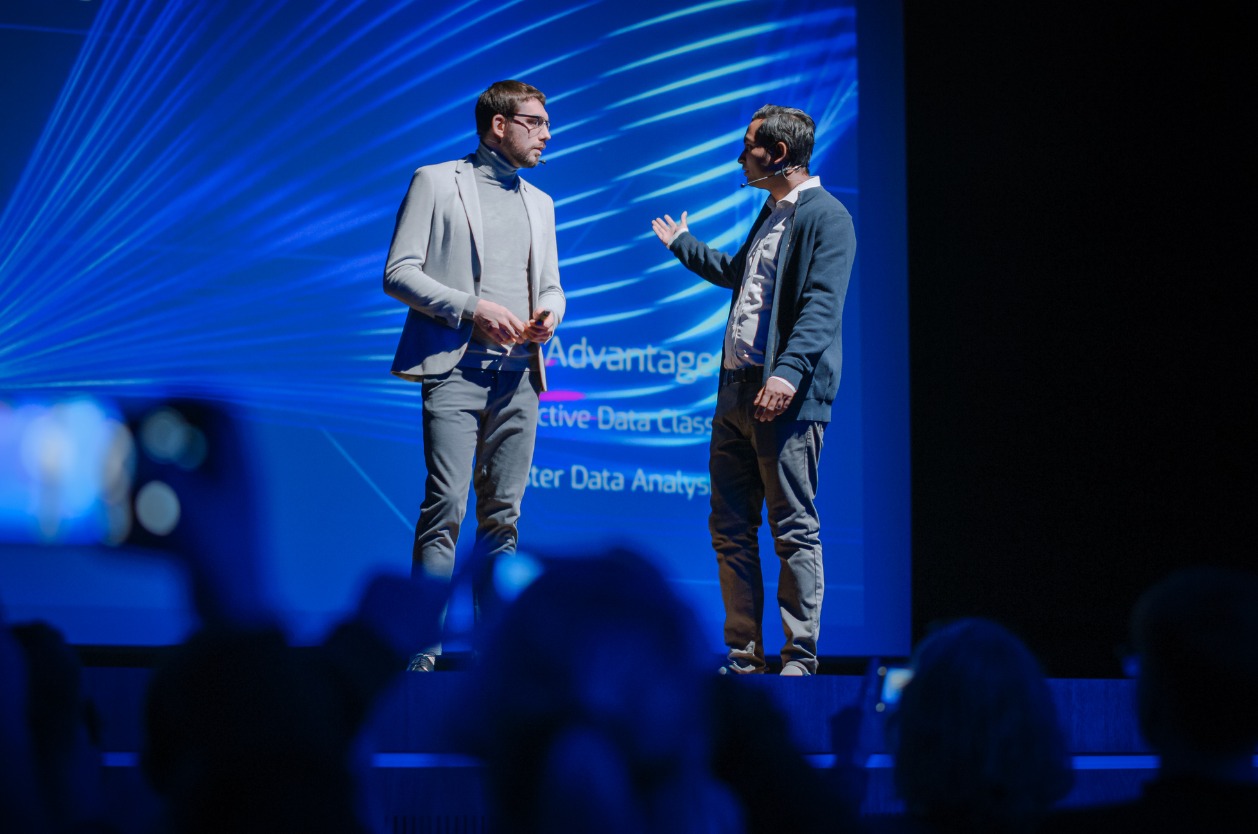 Attending Jacksonville technology conferences - Two male IT professionals discussing IT developments during a conference.