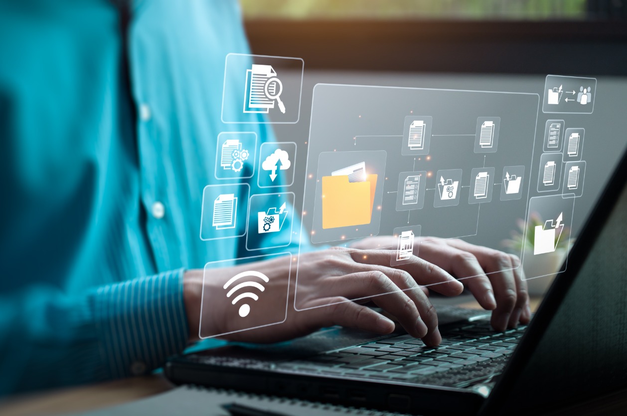 Using a shared network drive - A businessman using a laptop to manage company data.
