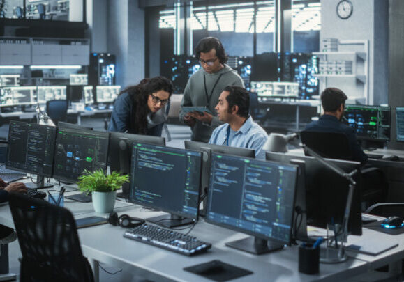 Partnering with MSPs - Group of MSPs in an office working on computers.