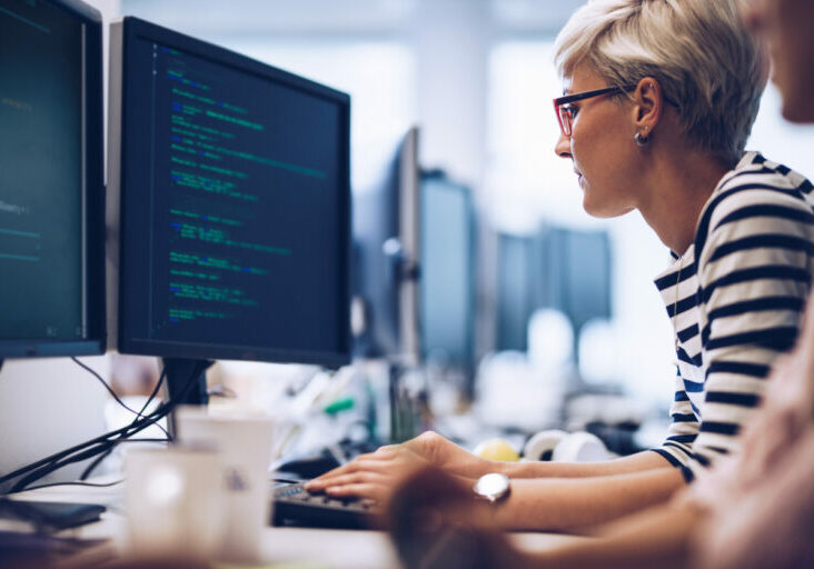 Partnering with a managed IT services provider - Female employee using a computer to perform tasks.